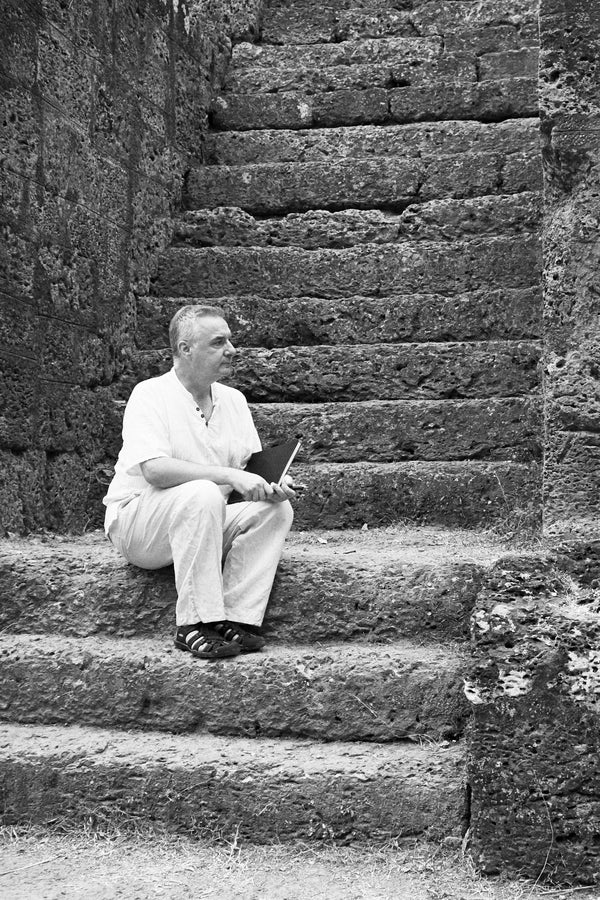 Lucas Varro sitting on stone temple steps